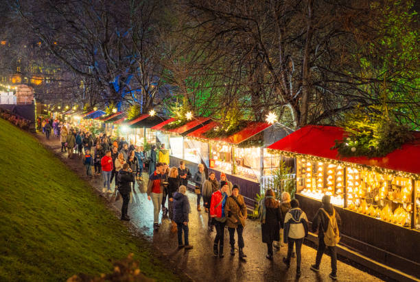 People passing Christmas market stalls in Edinburgh's Princes Street Gardens.