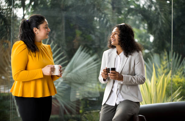 istock Two businesswomen discussing at office 1350664663