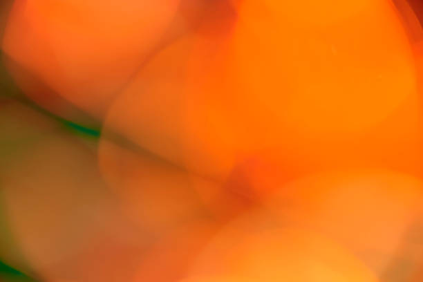 istock Abstract blurred orange and green lights background 1350665069