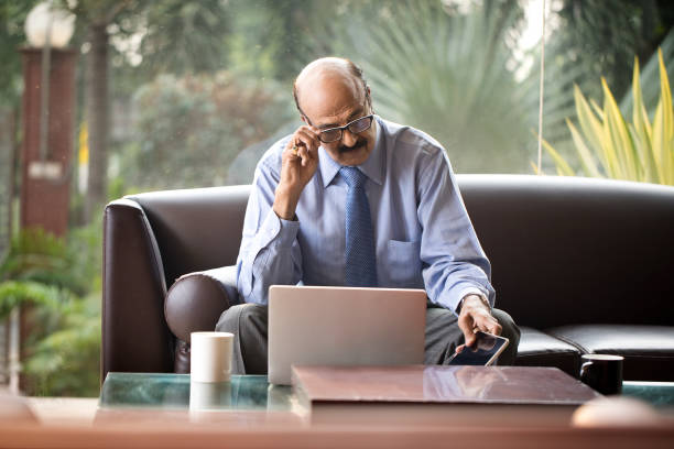 istock Senior businessman using laptop at office 1350666412