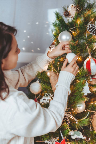 istock woman decoration christmas tree 1350667449