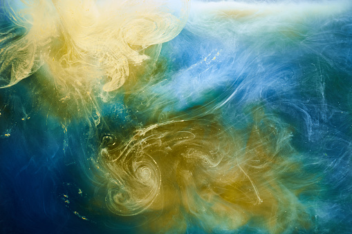 Earth colors abstract background, colorful smoke paint underwater, swirling ink in water, exoplanet blue yellow sea ocean