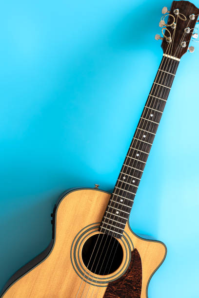 istock Acoustic guitar on a blue background, top view, copy space. 1350668128