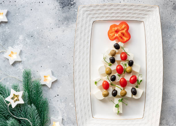 istock Christmas tree made of cheese, vegetables and microgreens 1350668386