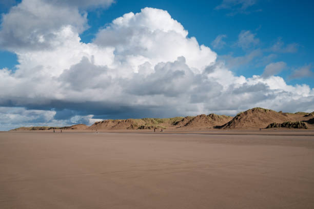 istock wide expanse of open empty beach with sand dunes and dramatic puffy white cloud sky 1350668727