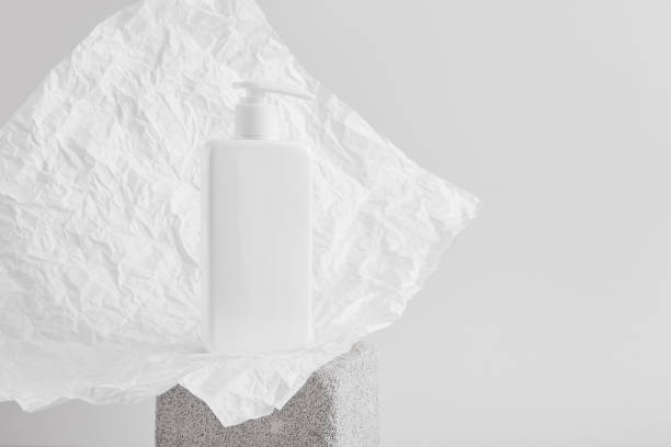 istock white bottle with a dispenser without a label on a gray concrete podium 1350669893