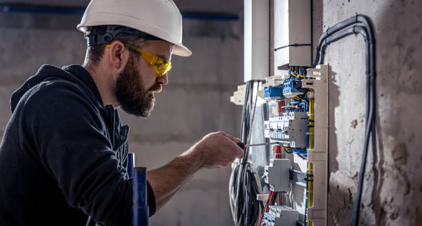 istock A male electrician works in a switchboard with an electrical connecting cable. 1350671020
