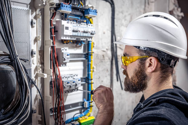 istock A male electrician works in a switchboard with an electrical connecting cable. 1350671030