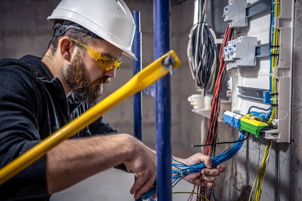 istock A male electrician works in a switchboard with an electrical connecting cable. 1350671035