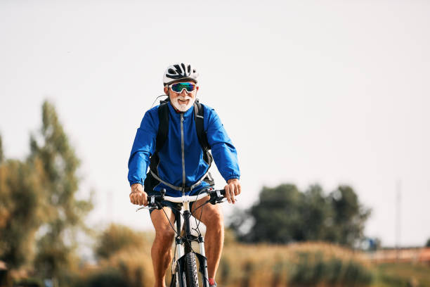 istock Happy senior athlete riding bicycle in nature. 1350671385