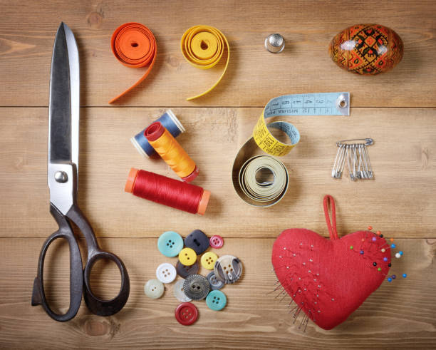 istock Tools and objects for tailoring on wooden tailor`s desk. Top view. 1350671430