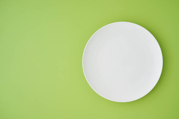 istock Horizontal flat lay of empty white circle plate. Clean tableware. Serving preparation. Cutlery set 1350672778