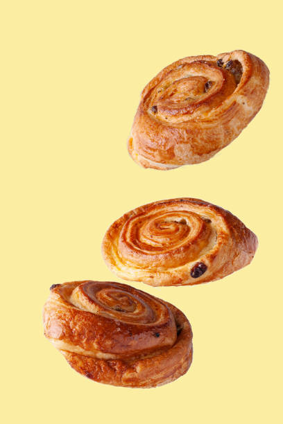 istock buns with raisins flying food selective focus on yellow background 1350674495