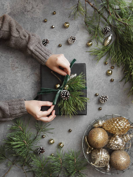 istock Woman decorating Christmas present 1350674597