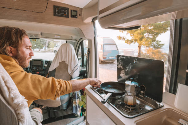 istock Man prepares coffee in his van, sea view 1350675459