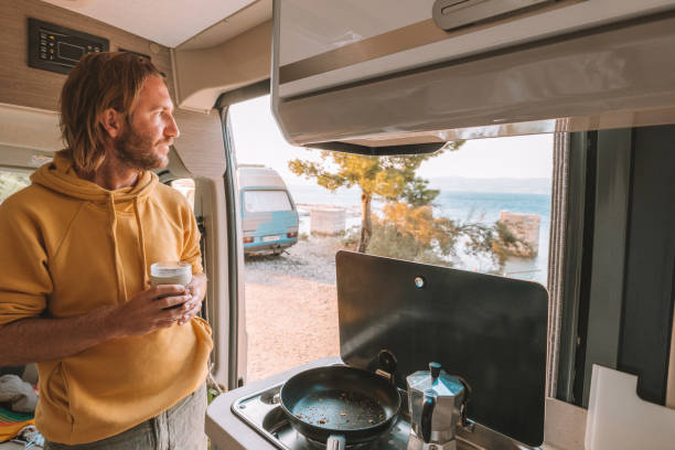 istock Man drinks coffee in his van, sea view 1350675493