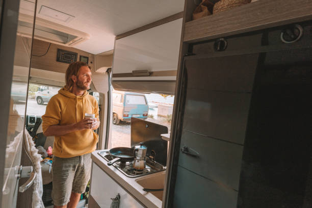 istock Man drinks coffee in his van, sea view 1350675500