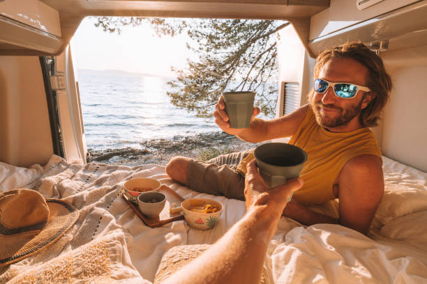 istock Couple in a van enjoying drinks at sunset 1350675860
