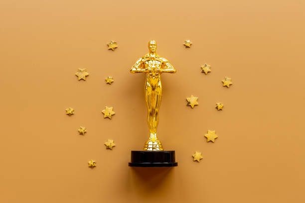 Golden movie award statue with stars - best film winner stock photo