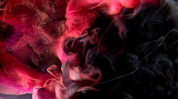 istock Red black pigment swirling ink abstract background, liquid smoke paint underwater 1350681475