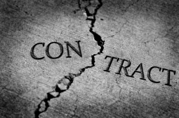 istock Cracked cement symbolizing a broken or breached contract ended and ceased 1350683257