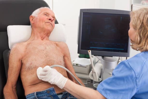 istock Female examines senior man with ultrasonic device 1350685824