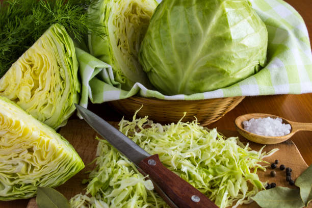 istock Chopped cabbage on the  brown wooden background. Close-up. 1350685904