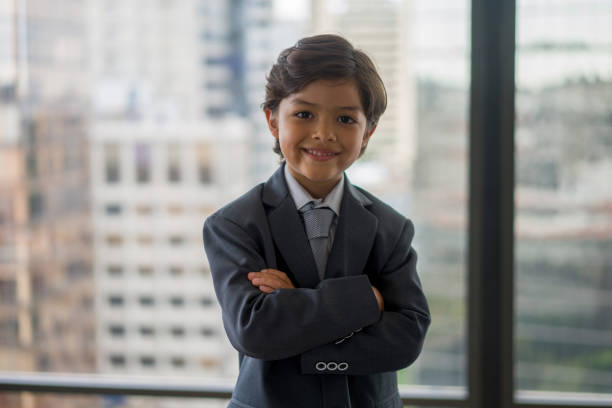 Portrait of a young Latin American business man smiling at the office and looking at the camera with arms crossed