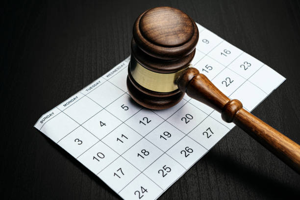 istock Wooden mallet on calendar page on table 1350688834