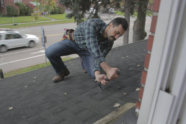 istock Roofer removing shingle from residential roof 1350689236