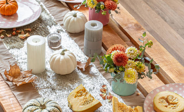 istock Festive table setting with pumpkins and chrysanthemum flowers. 1350690896
