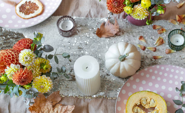 istock Festive table setting with pumpkins, candles and chrysanthemum flowers. 1350690900