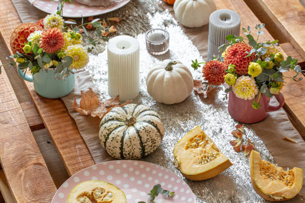 istock Festive table setting with pumpkins, candles and chrysanthemum flowers. 1350690902