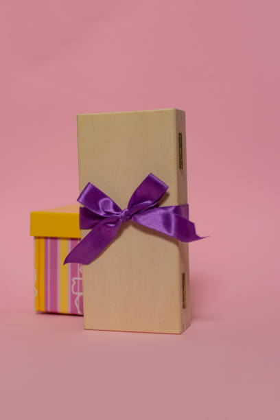 istock Gift boxes on the colored backgrounds, birthday gift, christmas present, with ribbon bow, valentine day surprise, birthday concept. Flat lay, top view. 1350692353
