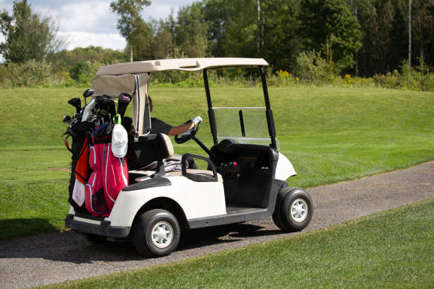 istock Golf Player Riding in Golf Cart 1350692448