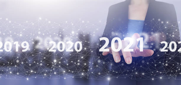 istock Loading year 2021. Start concept. Hand touch digital screen hologram 2021 sign on city light blurred background. Concept Start New Year 2021 1350695487