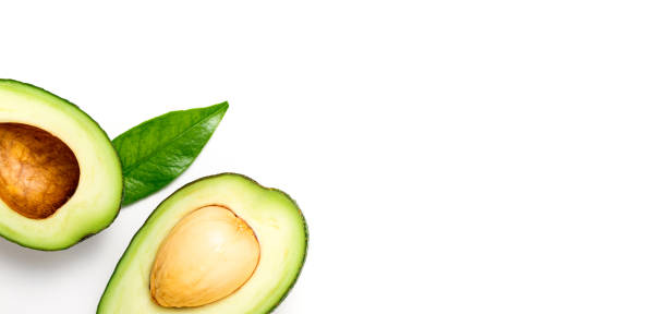 istock Avocado on white background. Tropical abstract background with avocado and leaf. Flat lay. Top view 1350695548