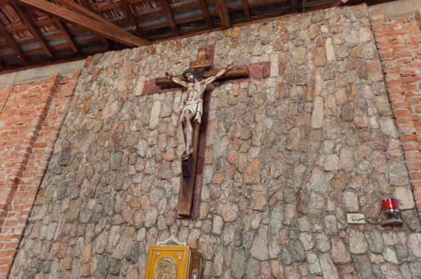 istock Christ on the cross on rustic looking wall 1350696812