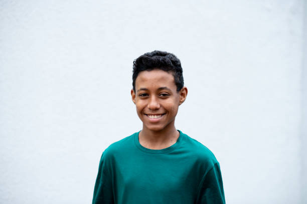 Black boy portrait. Portrait of black boy smiling and looking at camera. White background. teenager boy haircuts stock pictures, royalty-free photos & images