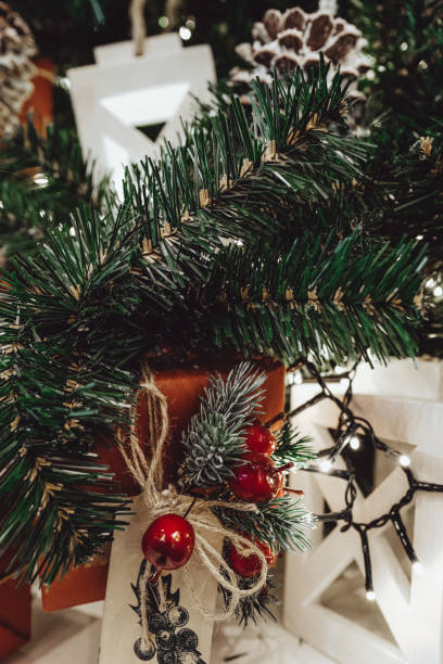 istock Festive gift boxes on the Christmas tree, New Year decorations, paper wrapping of Santa presents, festive details, traditional celebration. 1350699310