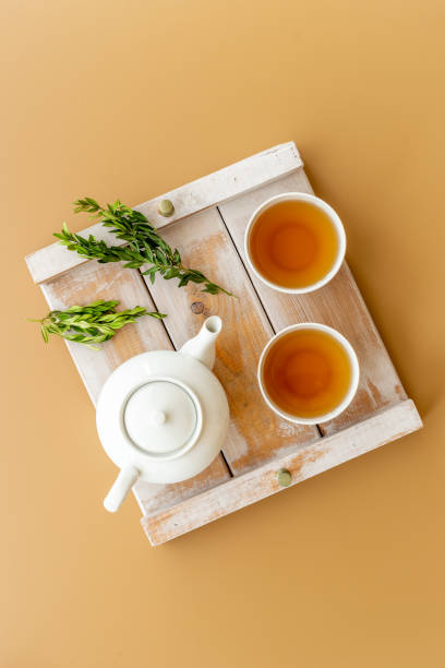 istock Two cups of tea with white teapot, top view 1350699484