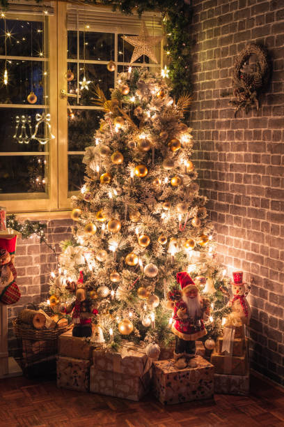 istock Decorated Christmas Tree Near Fireplace at Home 1350699601