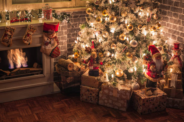istock Decorated Christmas Tree Near Fireplace at Home 1350699615