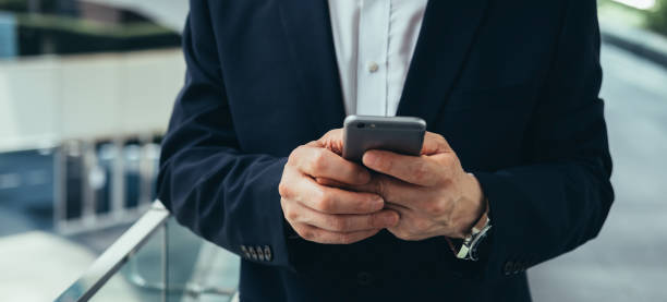 istock An Anonymous Asian Businessman Using Mobile Phone Outdoors 1350699912