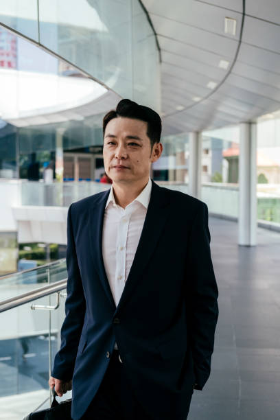 istock Serious Asian Businessman Going to Work 1350699935