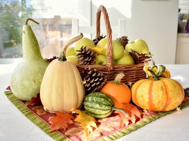 istock Fall harvest dinner table decorative centrepiece with autumn squash, pumpkins and apples 1350701085