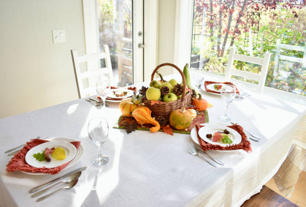 istock Fall harvest dinner table decorative centrepiece with autumn squash, pumpkins and apples 1350701117
