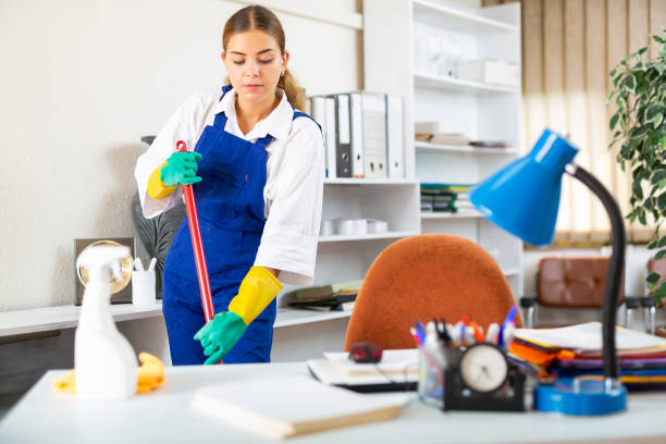 istock Young woman cleaning office 1350701169