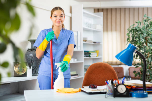 Woman cleaning floor with mop Young woman in surgical scrubs cleaning floor. She's using mop and rubber gloves. cleaner stock pictures, royalty-free photos & images