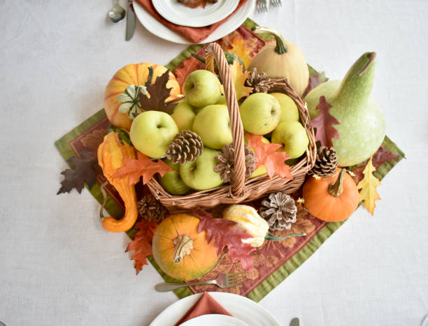 istock Fall harvest dinner table decorative centrepiece with autumn squash, pumpkins and apples 1350701255